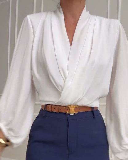 Blouse à manches bouffantes avec décolleté en V de couleur unie