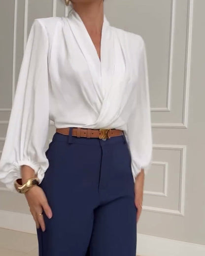 Blouse à manches bouffantes avec décolleté en V de couleur unie